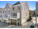 Rear view of modern townhomes featuring balconies, garage, and outdoor space at 2035 Parkside Ln, Roswell, GA 30076