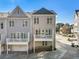 Rear exterior view showcasing multiple townhomes with decks and garage access at 2035 Parkside Ln, Roswell, GA 30076