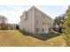 The backyard and exterior of a home, with a large lawn and mature trees at 2123 Indian Ivey Ln, Dacula, GA 30019