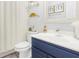 Cozy bathroom with a blue vanity, white countertops, and stylish decorations at 2123 Indian Ivey Ln, Dacula, GA 30019