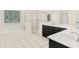 Bright bathroom with a large soaking tub, double vanities, and a walk-in shower at 2123 Indian Ivey Ln, Dacula, GA 30019