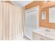 Bathroom with bright window, shower and tub combination, and neutral color scheme at 2123 Indian Ivey Ln, Dacula, GA 30019
