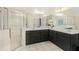 Clean bathroom featuring double sinks, a large mirror, and a separate glass-enclosed shower at 2123 Indian Ivey Ln, Dacula, GA 30019