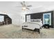 Spacious bedroom with a ceiling fan, a decorative rug, and a sitting area with built in book shelves at 2123 Indian Ivey Ln, Dacula, GA 30019
