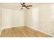 Cozy bedroom featuring wood-look flooring, neutral walls, and a ceiling fan at 2123 Indian Ivey Ln, Dacula, GA 30019