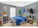 Bedroom includes window, sport themed decor, and furniture at 2123 Indian Ivey Ln, Dacula, GA 30019