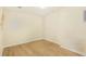 Bright bedroom with wood-look flooring, white trim, and neutral walls at 2123 Indian Ivey Ln, Dacula, GA 30019