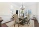Formal dining room with wainscoting, chandelier, and views of the front yard at 2123 Indian Ivey Ln, Dacula, GA 30019