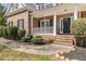 Charming front porch with white railing, brick accents, and a welcoming wreath on the front door at 2123 Indian Ivey Ln, Dacula, GA 30019