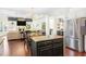 Open-concept kitchen featuring a central island, granite countertops, and hardwood flooring, with an airy layout at 2123 Indian Ivey Ln, Dacula, GA 30019