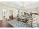 Spacious living room featuring hardwood floors, a large sectional, and a view into the kitchen at 2123 Indian Ivey Ln, Dacula, GA 30019