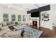 Spacious living room featuring coffered ceilings, built-in bookshelves, and a cozy fireplace at 2123 Indian Ivey Ln, Dacula, GA 30019