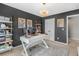 Home office with built-in shelving, a modern desk, and grey walls at 2123 Indian Ivey Ln, Dacula, GA 30019