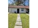 Large backyard with grassy lawn and a tidy path leading to the back entrance at 6071 Deerfield Ct, Morrow, GA 30260