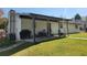 Covered patio extending from the home offers an outdoor dining and entertainment space with grill at 6071 Deerfield Ct, Morrow, GA 30260