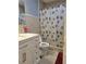 Well-lit bathroom featuring a vanity, mirror and shower/tub combination at 6071 Deerfield Ct, Morrow, GA 30260