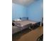 Bedroom with two beds, ideal for roommates or guests, with carpeted floors and blue painted walls at 6071 Deerfield Ct, Morrow, GA 30260