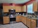 Updated kitchen with stainless steel appliances and granite countertops at 6071 Deerfield Ct, Morrow, GA 30260