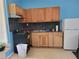 Functional kitchen featuring wooden cabinetry, black appliances, and a neutral countertop at 6071 Deerfield Ct, Morrow, GA 30260