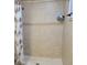 Tiled shower featuring a shower curtain, tiled walls, and updated fixtures at 6071 Deerfield Ct, Morrow, GA 30260