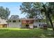 Expansive backyard featuring a deck, lush lawn, and mature trees at 3918 Artist Vw, Decatur, GA 30034