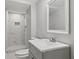 Bathroom with modern vanity, neutral color palette, and tiled shower with seat at 3918 Artist Vw, Decatur, GA 30034