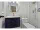 Bathroom featuring a navy vanity, modern fixtures, and tiled shower with glass door at 3918 Artist Vw, Decatur, GA 30034