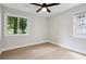 Bedroom featuring light hardwood floors, ceiling fan, stained-glass window, and bright natural light at 3918 Artist Vw, Decatur, GA 30034