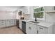 Updated kitchen with white cabinets, stainless steel appliances, and quartz countertops at 3918 Artist Vw, Decatur, GA 30034