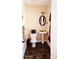 Well-lit half bathroom featuring tile flooring, a pedestal sink, and an oval mirror at 504 Liverpool Dr, Mcdonough, GA 30252