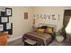 Cozy bedroom featuring carpeted floors, ample natural light, and decorative accents at 504 Liverpool Dr, Mcdonough, GA 30252