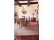 Cozy dining room with modern chandelier, coffered ceilings, and a glass top table with seating for six at 504 Liverpool Dr, Mcdonough, GA 30252