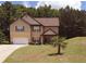 Charming two-story home featuring a well-manicured lawn and a driveway leading to an attached garage at 504 Liverpool Dr, Mcdonough, GA 30252