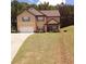 Two-story home with a two-car garage, lush lawn, and carefully manicured landscaping at 504 Liverpool Dr, Mcdonough, GA 30252