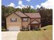 Inviting two-story home featuring a well-manicured lawn, cozy porch, and an attached two-car garage at 504 Liverpool Dr, Mcdonough, GA 30252