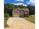 Beautiful two-story home with an attached garage, a lush lawn, and mature trees at 504 Liverpool Dr, Mcdonough, GA 30252