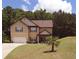 Inviting two-story home featuring a well-manicured lawn, cozy porch, and an attached two-car garage at 504 Liverpool Dr, Mcdonough, GA 30252