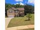 Charming home with a well-manicured lawn, mature trees, and a two-car garage at 504 Liverpool Dr, Mcdonough, GA 30252