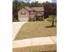 Inviting two-story home featuring a well-manicured lawn, cozy porch, and an attached two-car garage at 504 Liverpool Dr, Mcdonough, GA 30252