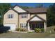 Charming two-story home featuring a well-manicured lawn, complemented by decorative shrubs and tasteful landscaping at 504 Liverpool Dr, Mcdonough, GA 30252