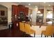 Kitchen with rich wood cabinetry, stainless steel appliances, breakfast bar, and hardwood floors at 504 Liverpool Dr, Mcdonough, GA 30252