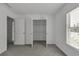 A bright bedroom featuring an open closet with shelving and a sunlit window at 2377 Proctor Creek Enclave, Acworth, GA 30101