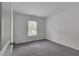 Bright bedroom with a neutral color palette, large window, and plush gray carpet at 2377 Proctor Creek Enclave, Acworth, GA 30101