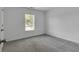 Bright bedroom with a neutral color palette, large window, and plush gray carpet at 2377 Proctor Creek Enclave, Acworth, GA 30101