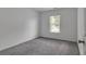 Bright bedroom with a neutral color palette, large window, and plush gray carpet at 2377 Proctor Creek Enclave, Acworth, GA 30101