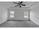 Large bedroom features neutral carpet, ceiling fan and two windows that provide natural light at 2377 Proctor Creek Enclave, Acworth, GA 30101
