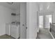 Hallway laundry featuring new, modern appliances and an open floorplan at 2377 Proctor Creek Enclave, Acworth, GA 30101