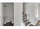Hallway with half bathroom and staircase featuring wood steps and iron balusters at 2377 Proctor Creek Enclave, Acworth, GA 30101