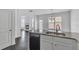 The kitchen features a breakfast bar, double sinks, granite countertops and open access to other rooms at 2377 Proctor Creek Enclave, Acworth, GA 30101