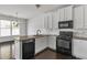 Bright kitchen features granite countertops, white cabinets, and stainless-steel appliances at 2377 Proctor Creek Enclave, Acworth, GA 30101
